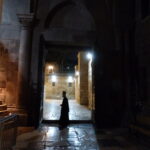A Greek Orthodox priest in the doorway of the Church of the Holy Sepulchre (Seetheholyland.net)