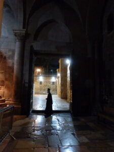 A Greek Orthodox priest in the doorway of the Church of the Holy Sepulchre (Seetheholyland.net)