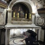 A pilgrim knees in the Grotto of the Benedictus in the Church of St John the Baptist (Kristina Fuiava / Seetheholyland.net)