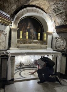 A pilgrim knees in the Grotto of the Benedictus in the Church of St John the Baptist (Kristina Fuiava / Seetheholyland.net)