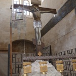 Crucifix standing over piece of rock of Calvary (Seetheholyland.net)