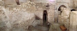 Panoramic view of first-century house with surviving plaster at far left (© Gregory Jenks)