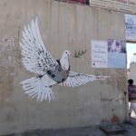 Peace symbol among graffitti on separation wall in Bethlehem (Seetheholyland.net)