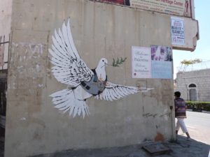 Peace symbol among graffitti on separation wall in Bethlehem (Seetheholyland.net)