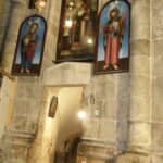 Restored paintings of holy people over the steps to the lower chapels in the Church of the Holy Sepulchre (Seetheholyland.net)