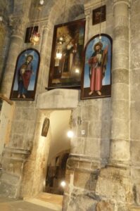 Restored paintings of holy people over the steps to the lower chapels in the Church of the Holy Sepulchre (Seetheholyland.net)