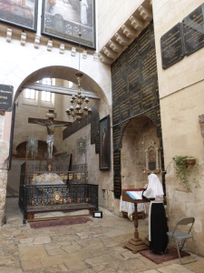 Russian nun praying in front of "Judgement Gate" threshold (Seetheholyland.net)