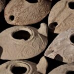 Oil lamps uncovered during the archaeological excavation at Salome's Cave. (©️Emil Eljam / Israel Antiquities Authority)