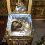 Icon depicting head of John the Baptist on a platter, beside a jewelled silver case containing a piece of a skull said to be a relic of the saint (© Holy Land Photos)