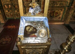 Icon depicting head of John the Baptist on a platter, beside a jewelled silver case containing a piece of a skull said to be a relic of the saint (© Holy Land Photos)