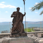 Statue of St Peter at Capernaum, with Sea of Galilee in background (Seetheholyland.net)