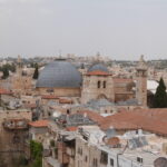 The Church of the Holy Sepulchre stands amidst an untidy clutter of roofs with television discs, solar panels and water tanks (Seetheholyland.net)