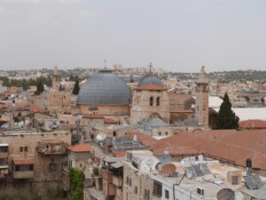 The Church of the Holy Sepulchre stands amidst an untidy clutter of roofs with television discs, solar panels and water tanks (Seetheholyland.net)